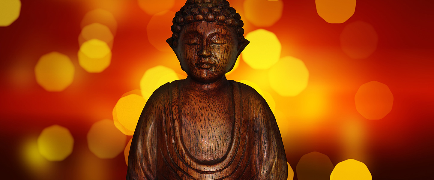 Buddha statuette and bokeh lights