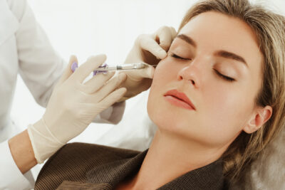 Woman receiving Botox facial filler injections as part of medical aesthetics treatment