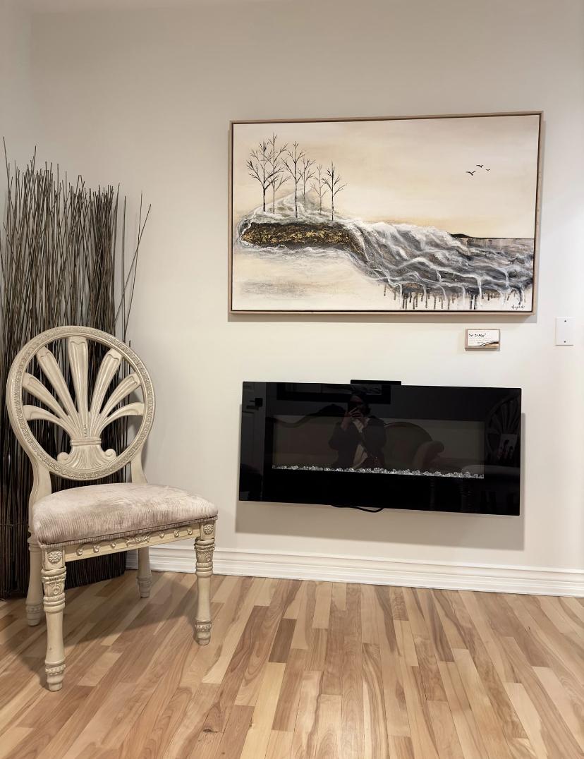 Chair next to fireplace, wall with beautiful scenic painting